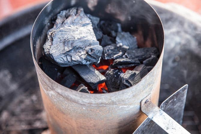 coals lit in chimney starter showing embers and ash