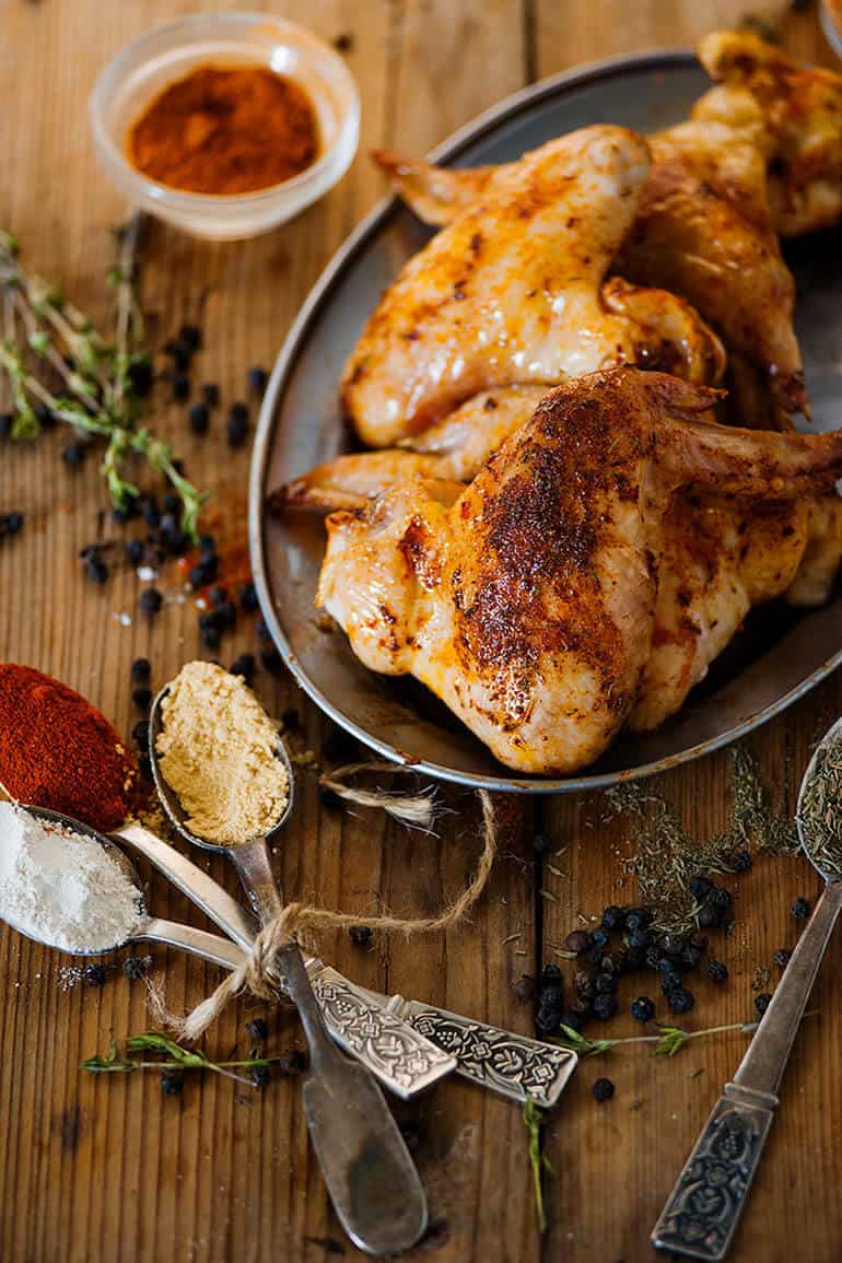 whole chicken and rub ingredients prepared on table