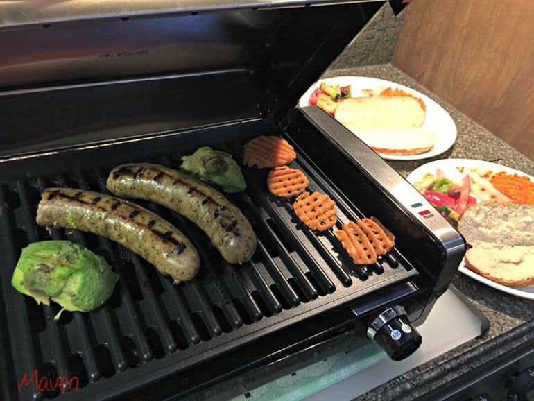sausages and vegetables cooking on hamilton beach grill