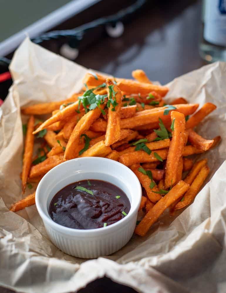 bbq sauce presented next to sweet potato fries