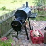 charcoal offset smoker on outdoor patio
