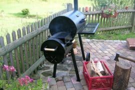 charcoal offset smoker on outdoor patio