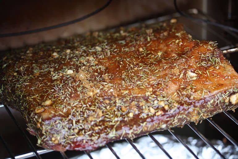 coated brisket in smoker