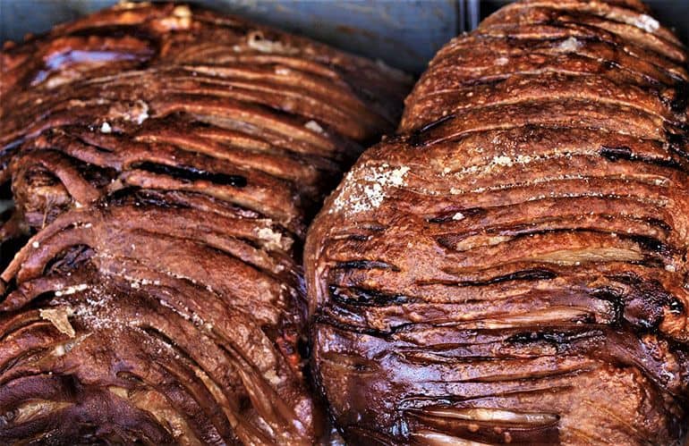 two whole sliced briskets resting after smoking