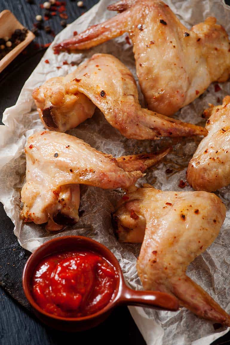 BBQ wings served next to spicy dipping sauce