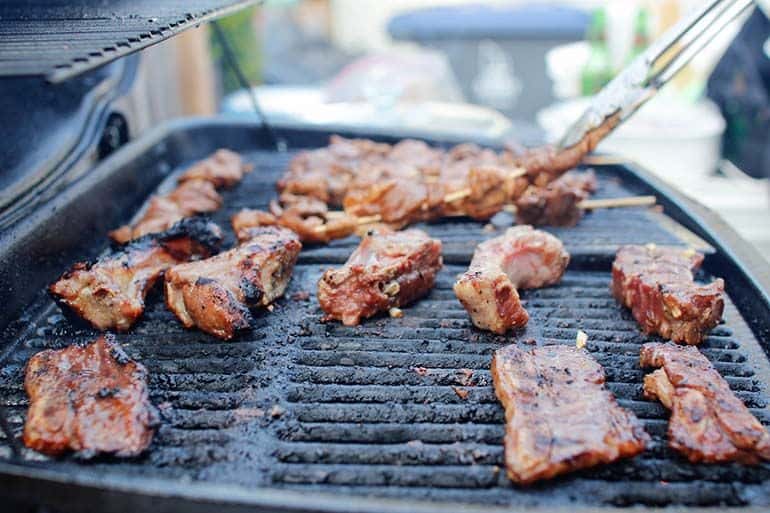 bbq rib platter cooking on large grill