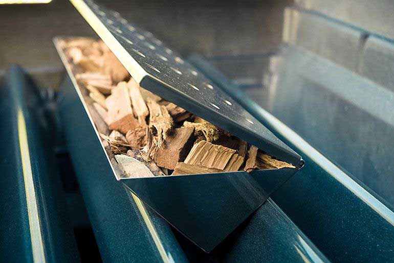 smoker box with wood chips on gas grill flavorizer bars