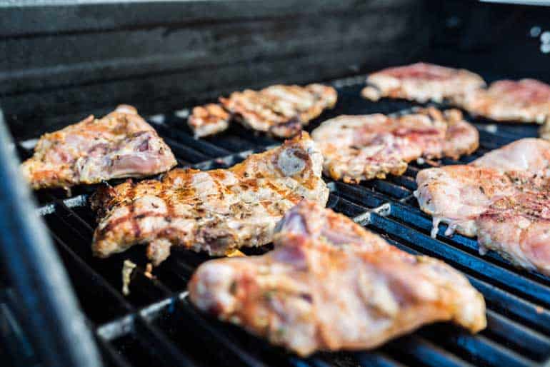 pork steaks cooking on grill