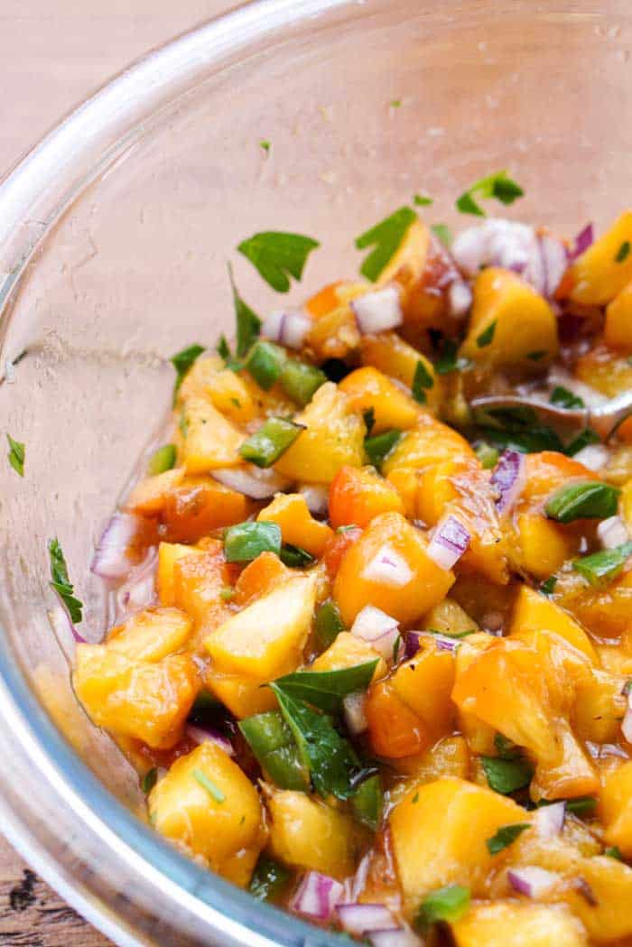 peach salsa mixing in bowl