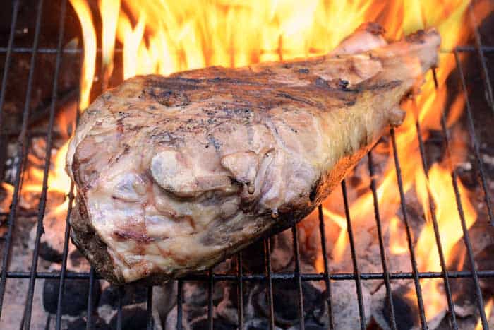 spiced leg of lamb on hot grill