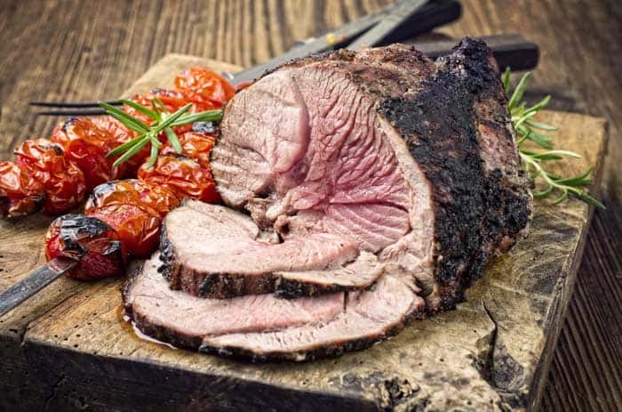 spiced leg of lamb on chopping board