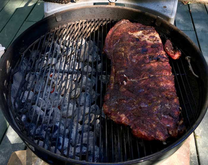 bbq ribs smoking on charcoal grill