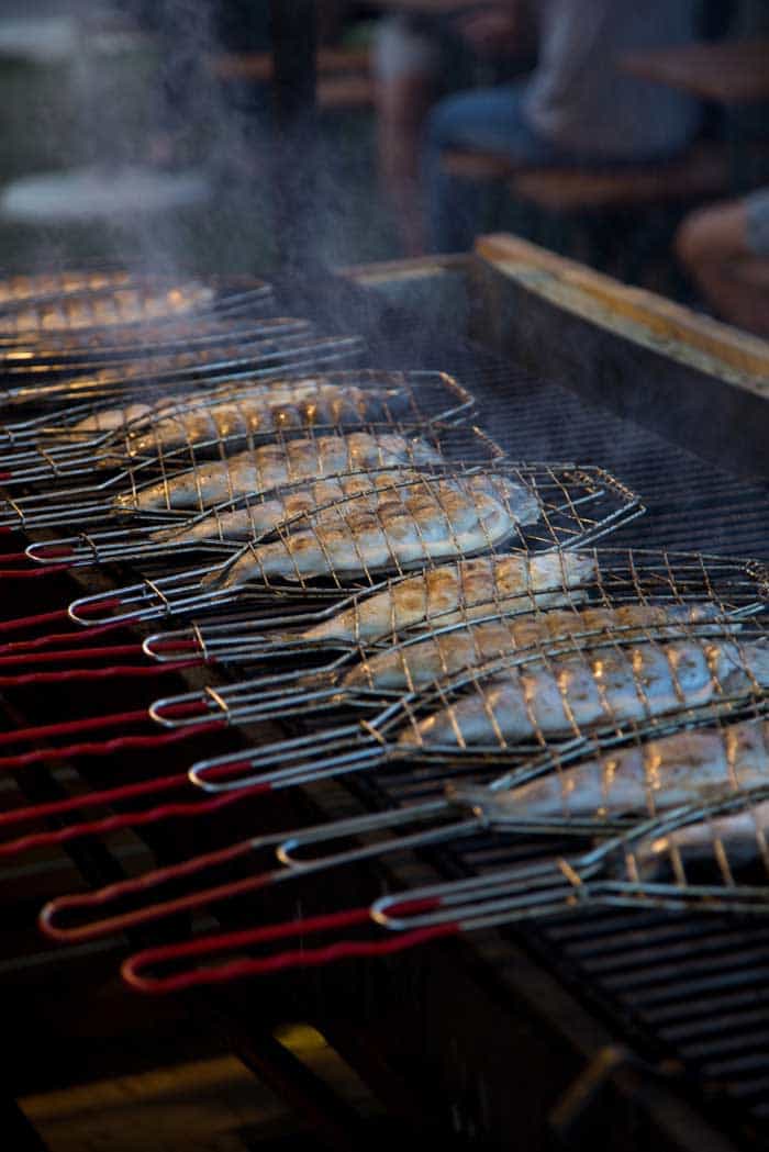 fish cooking in grill baskets