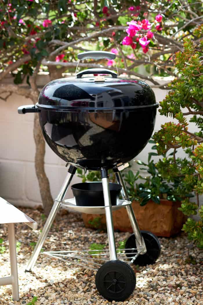 weber kettle charcoal grill on patio garden