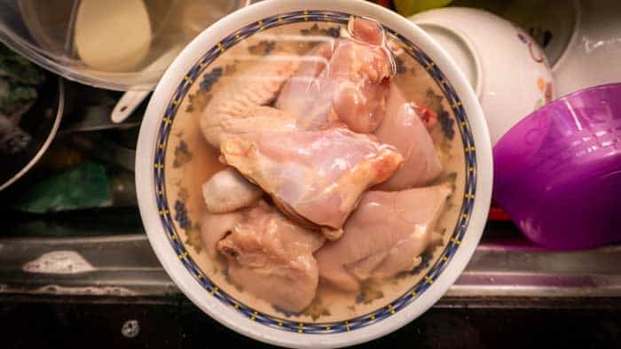 Close up view of raw chicken meat defrost in a lukewarm water after frozen in the fridge