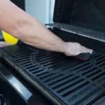 cleaning large black cast iron grills