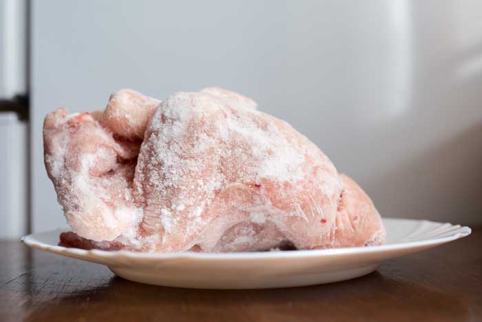 frozen chicken resting on counter plate