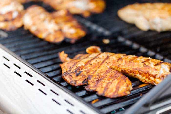 grilled fish resting on grill with sear marks
