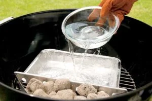 pouring water into grill water pan