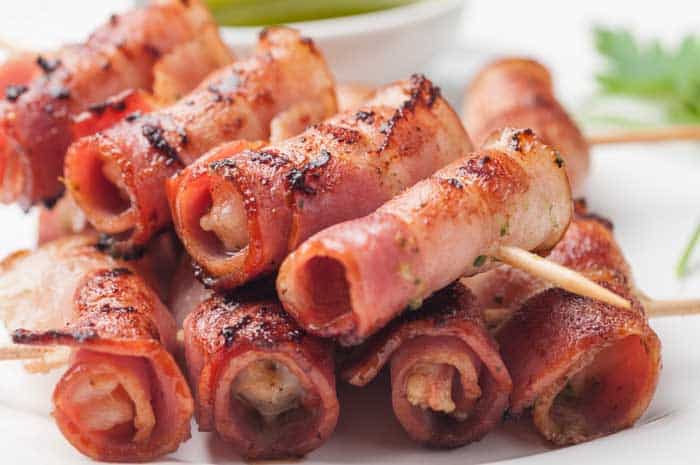 bacon skewers on white table background