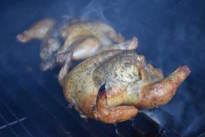 cornish hens smoking in grill
