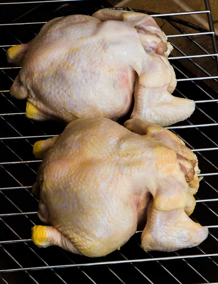 raw whole hen placed on smoking racks