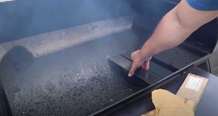 tuning and deflector plates being placed into open offset smoker chamber