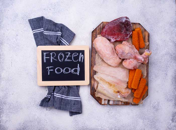selection of frozen meat on cutting board