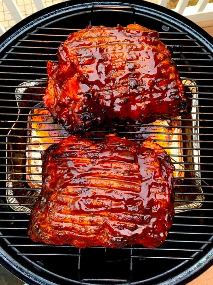 pork butt smoking on grill grates