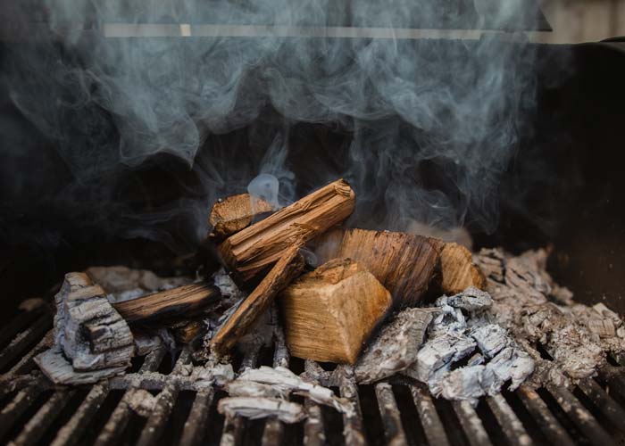 large wood chunks in charcoal smoker