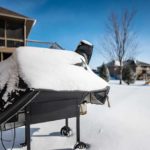 backyard barbecue smoker covered with welding blanket for winter