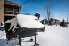 backyard barbecue smoker covered with welding blanket for winter