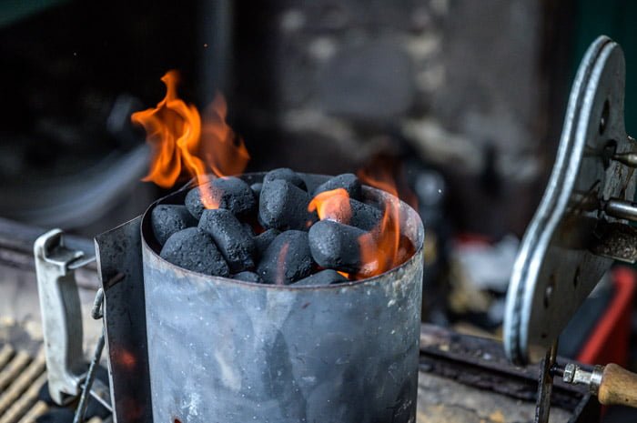 charcoal briquettes lit in chimney