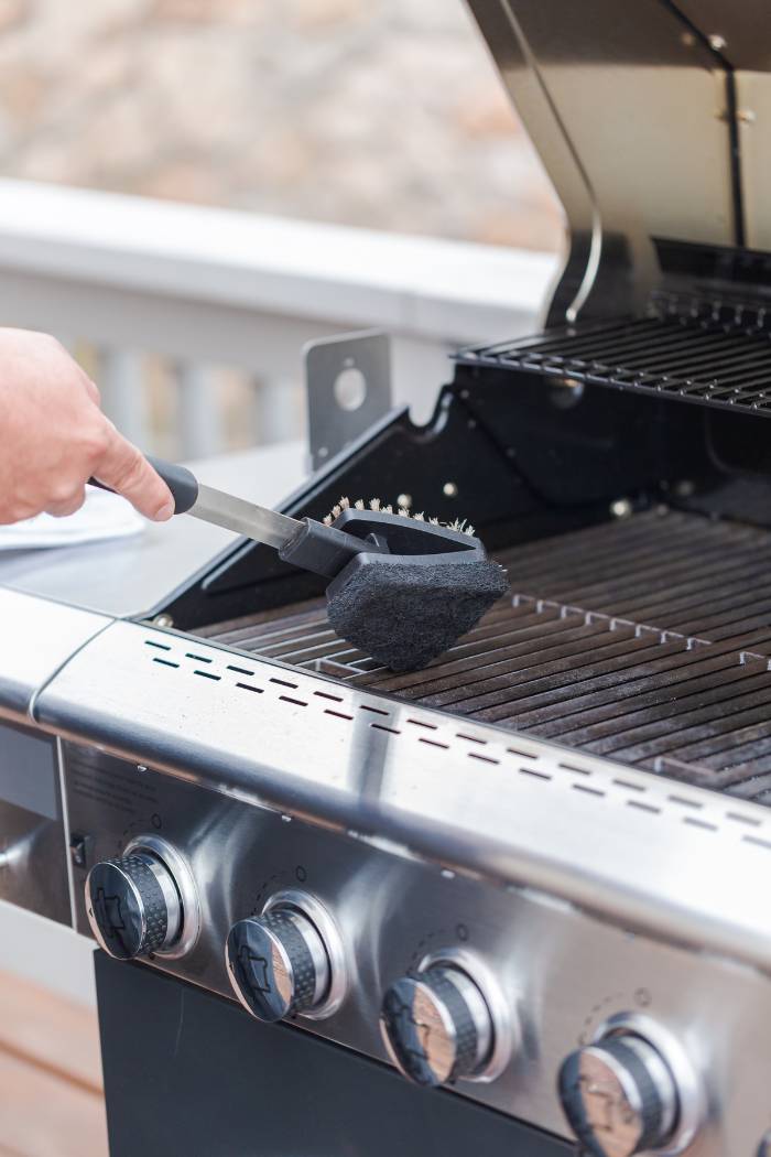 cleaning propane gas grill grates with a wire brush and sponge