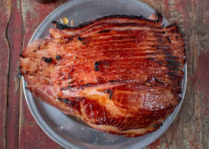 double smoked spiral ham resting on plate ready to serve