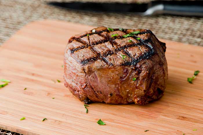 grilled beef filet mignon steak chopping board