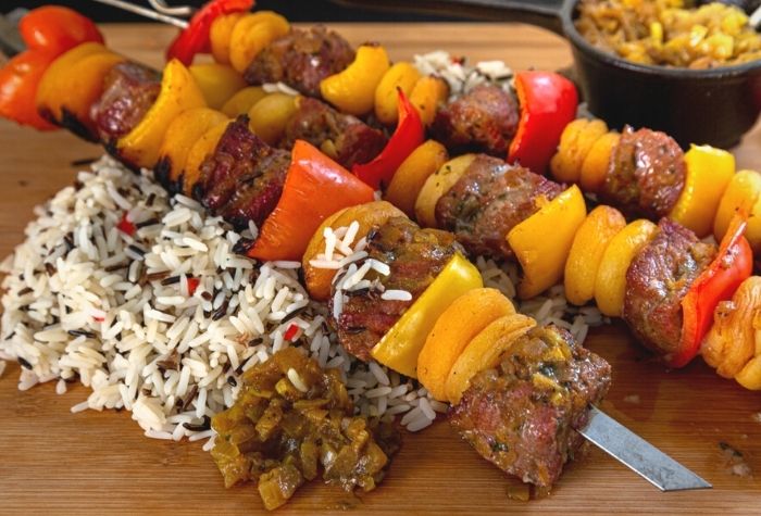 grilled lamb sosaties with bell peppers and apricots on metal skewers