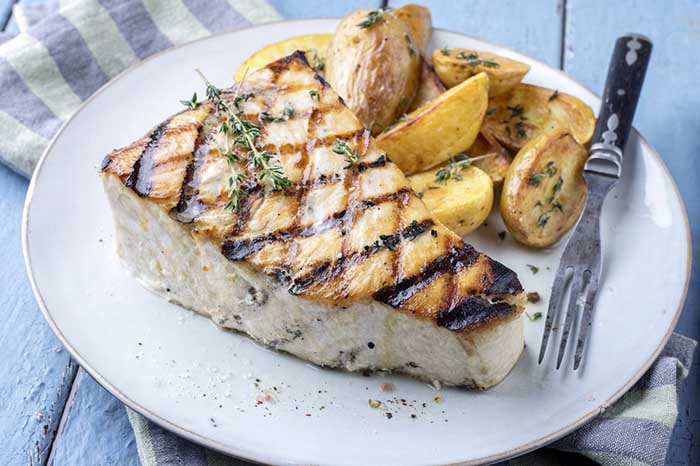 grilled swordfish steaks served with grilled potato herbed wedges