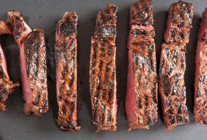 grilled wagyu ribeye steak charred from flame and sliced into strips