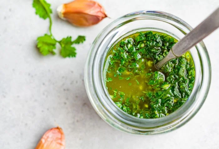 homemade chimichurri sauce in small glass jar ready to serve