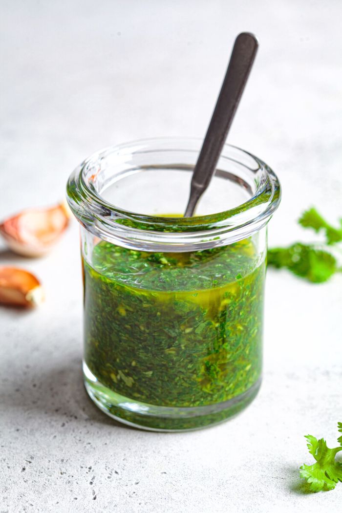 homemade chimichurri ready to serve in small glass jar