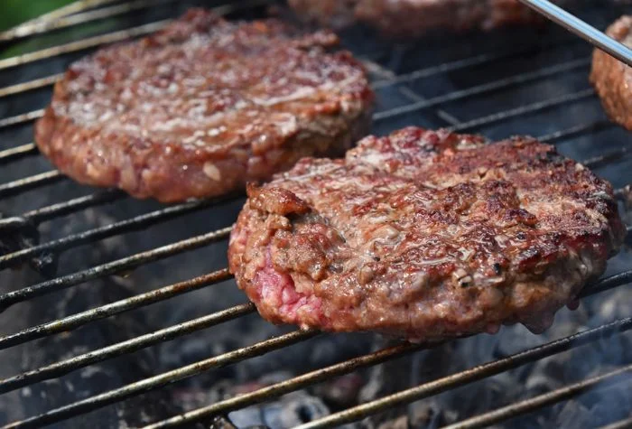 medium rare burgers on grill