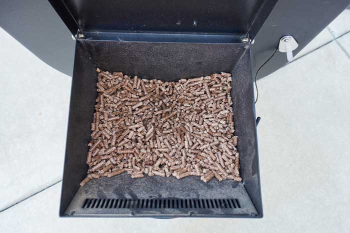 natural wood pellets in smoker hopper auger