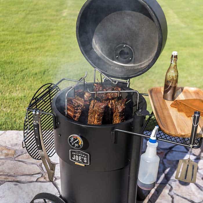 oklahoma joe bronco smoker with lid open and barbecue meat