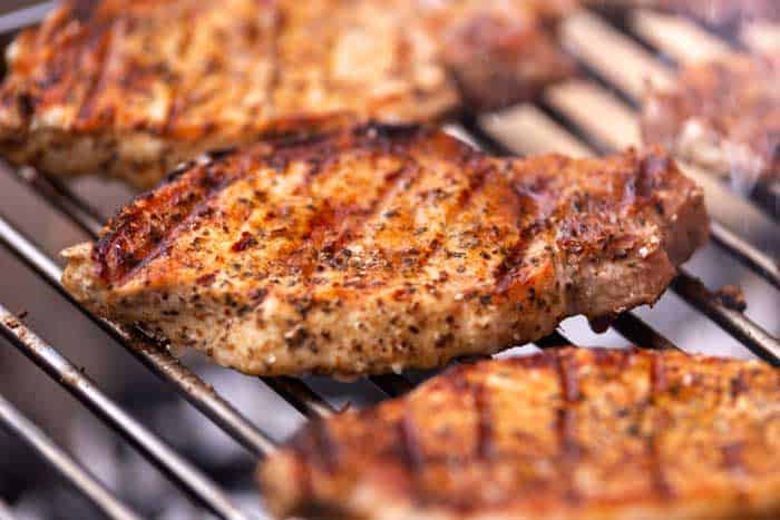 pork loin meat grilled on BBQ, barbecue open fire