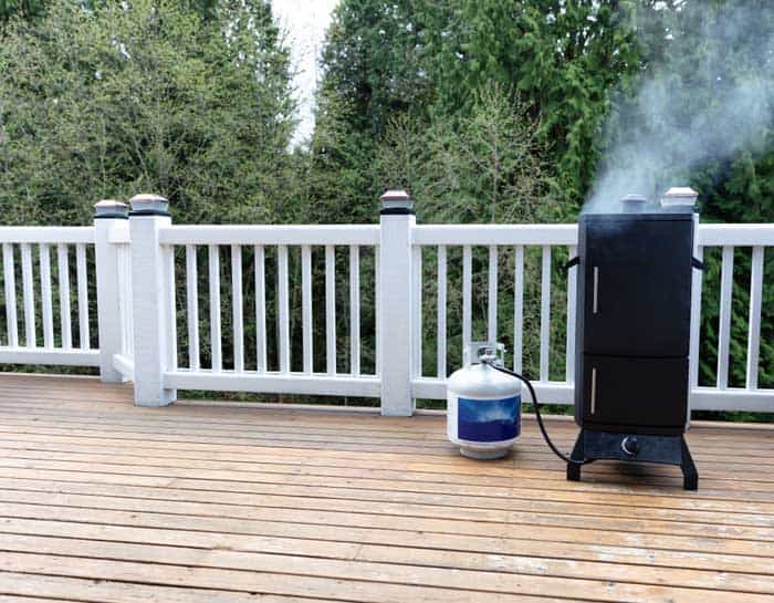 propane gas smoker on backyard patio
