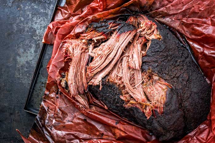 https://theonlinegrill.com/wp-content/uploads/pulled-beef-brisket-pink-butcher-paper-2.jpg