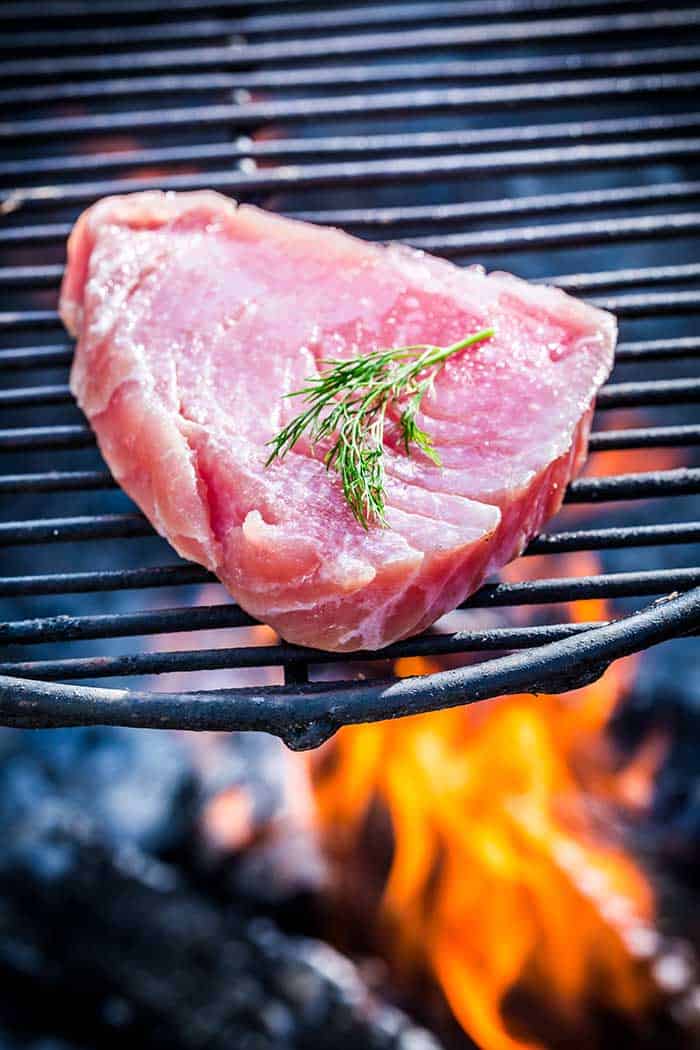 raw tuna steak fillet on charcoal grill