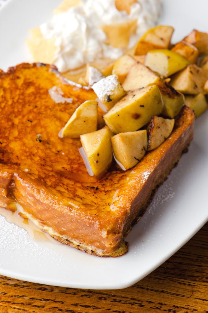 skillet grilled french toast with chopped fresh mango cubes and maple syrup