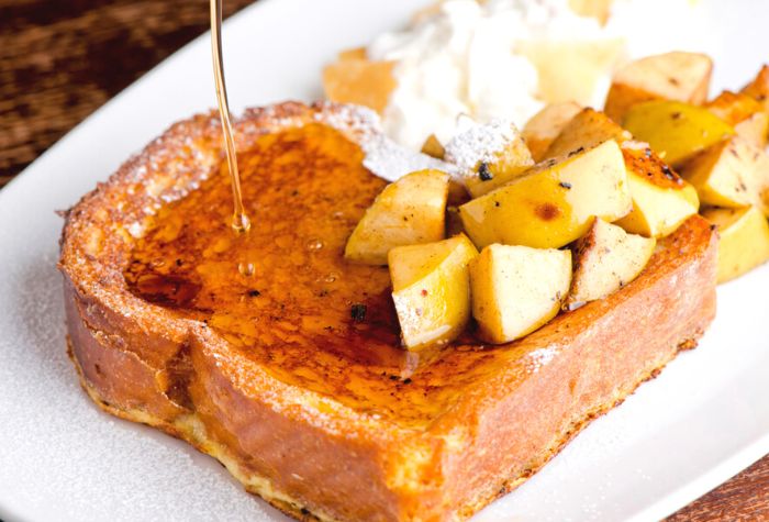 skillet grilled french toast served with fresh chopped mango, maple syrup and icing sugar